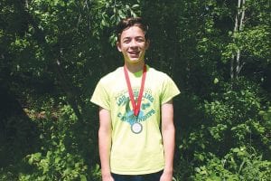 Dominic Wilson displays the medal he won at the Lacrosse Open log rolling tournament on June 18. Wilson had a great day and placed second in a very competitive U13 boys’ field.