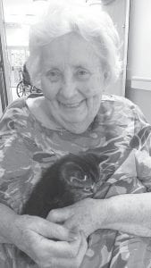 Pets are always welcome visitors at the Care Center. Cuddling with this cute visitor is Donna Willett.