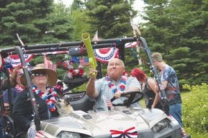 The 4th of July festivities in Tofte included some silliness, such as this parade participant who had a special shooter to launch candy into the crowd.