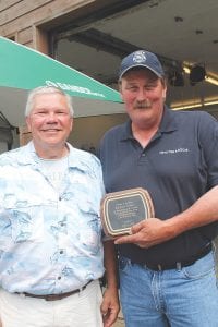 Above: With appreciation for all his years on the Tofte Fire Department and his work as fire chief, Tofte Supervisor Paul James (left) presented a plaque to Rich Nelson.