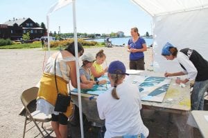 Brilliant blue skies were the perfect backdrop for the Grand Marais Arts Festival on July 9-10. Festival goers enjoyed the sunshine and the opportunity to create art at the Community Paint-By-Number booth. When finished, the painting will be installed on the northern wall of Birchbark Books in Grand Marais.