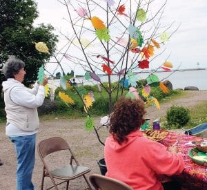 Left: Spirit of the Wilderness made a thoughtful addition to the festival with its “Decorate a Wish” tree. The leaves of the tree had many, many wishes for peace and kindness. Above: Bud Bullivant spent Sunday afternoon turning simple metal into intricate fish-shaped works of art.