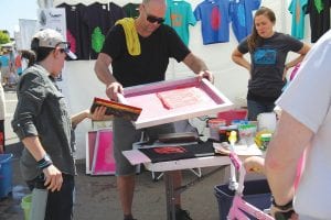 The streets of Grand Marais were crowded with visitors to the Grand Marais Arts Festival on July 9-10, enjoying art in a variety of forms. One of the favorite stops was at the Grand Marais Art Colony booth, which gave attendees the opportunity to screen print their own T-shirts—fun and fashionable art! See more about the Arts Festival on page A3.