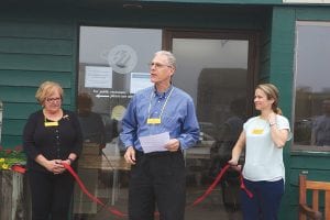 Before cutting the ribbon to officially open the Office Outpost, Bob Pranis of the Cook County Broadband Commission welcomed visitors and thanked all who had worked to create the telework facility. Joining him are fellow commission members Small Business Development Center Representative Pat Campanaro (left) and Mimi Gentz.