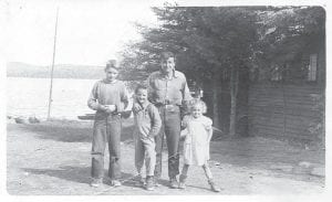 Above: Justine Kerfoot pauses for a moment from busy resort operation for a photo with her children. (L-R) Bruce, Pat, Justine and Sharon. Left: Living in the rugged, untamed wilderness, Bruce Kerfoot learned at an early age how to run a trap line.