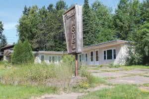 The former Fenstad Motel on 5th Avenue in Grand Marais has been vacant for many years, as is evident by the overgrown grass and bushes. The Grand Marais City Council approved a conditional use permit on July 13 that will allow Keith Bergeron to once again put the building to use.