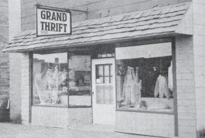 The July 13, 1972 edition of the Cook County News-Herald featured the newly completed facelifting of the Grand Thrift Shop, one of several remodeling tasks undertaken by local merchants that summer. The building, which was situated between the Ben Franklin store and Massie Motors on First Avenue West, was renovated with a cedar shake shingle façade and wood siding, all painted and stained in shades of brown and gold. The structure was later used as a storage building by Joynes Department Store. Sadly, the building was razed in April 2013 due to its advanced state of deterioration.