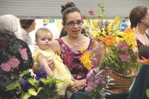 Flowers everywhere! Monica Anderson and her daughter Edith enjoy the colorful displays at the Grand Marais Garden Club Flower Show on Friday, July 22. See more of the Grand Marais Flower Show, as well as the West End Flower Show on page B4.