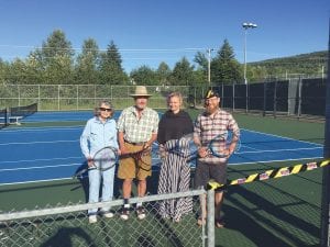 Helping to celebrate the July 28 grand opening of the two newly reconstructed tennis courts at the community center were (L-R) Frankie Jarchow, Bill Hennessy, president of the Cook County Tennis Association, Cook County Commissioner Heidi Doo-Kirk and Grand Marais Mayor Jay Arrowsmith DeCoux.