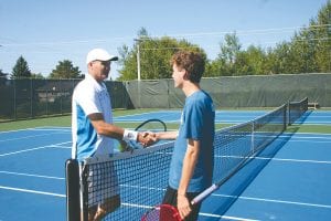 Former tennis pro David Wheaton shakes hands with Pete Summers after the two hit balls for about 10 minutes. Summers, who just graduated from high school, will play tennis next year at Lake Superior State University in Sault St. Marie, Michigan.