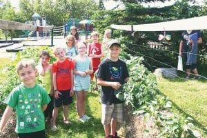 YMCA Kids Camp participants are having a great summer in the garden. (L-R, front) Alex Teter, Ahriana Liljestrand, Gary Thompson, Kirra White, Rayce Gibson. (L-R, middle) Alexis Plummer, Jake Mixdorf. (L-R, back) Nevaeh Sifferath, Greta Roth.