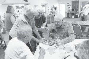 The Old-Timers Gathering sponsored by the Senior Center and the Cook County Historical Society on Friday, August 5 was enjoyed by all. The historical society provided old photos that need identification which spurred lots of conversation. (L-R) Eleanor Waha, Ethel Johnson, Lou Goodell, Wayne Anderson.