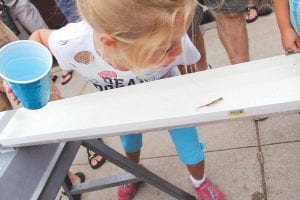 The Minnow Races, coordinated by Lion Myron Bursheim, had kids lined up around the block by the Beaver House on Friday. Above: Gabriella gives her minnow some motivation. It worked! Gabriella took 1st place. The other winners were Ella Ford and Elsa Eckman.