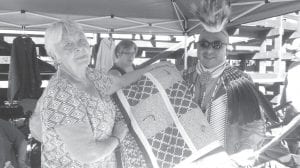 Carol Hackett presents the lovely Elders raffle quilt, which was won by Roger “Bouda” Smith Sr. from Fond du Lac.