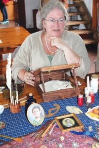 Above: There were no cameras at Rendezvous Days of old. People like miniature portrait artist Kelly James helped preserve memories of the era. Right: This device is a rudimentary rotisserie. It is wound tight and slowly turns over a campfire for about an hour. The blacksmith made a new hook for it and it was used in the encampment later for roasting a bear.