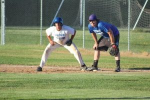 Glove on his knee, Sammy Warren seems to be daring Troy Berneking to take a lead off of first base. Berneking played on the first CCHS baseball team.