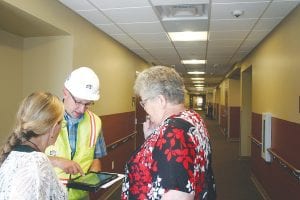 After taking a tour of the new Care Center rooms, hospital board members Kay Olson (left) and Sharon Bloomquist discuss some of the upcoming plans for landscaping with DSGW architect John Geisler. The work for the $24.5 million renovation and addition to the hospital and care center will take two years to complete.