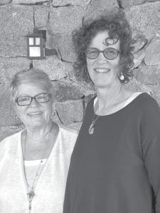 Gunflint Trail Historical Society (GTHS) Event Chairperson Judy Edlund and President Barb Bottger enjoy the breezy view from the Chik-Wauk Museum porch during the annual Pie & Ice Cream Social.