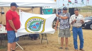 A group of band members of the Grand Portage Band of Lake Superior Chippewa traveled to Cannonball, North Dakota to show solidarity with the Standing Rock Sioux Tribe in its opposition to the Dakota Access Pipeline. Bob Deschampe (left) and Joe Porter brought a resolution of support from the Grand Portage Tribal Council. They proudly held the Grand Portage flag as Standing Rock Sioux Councilman Joe Dunn read the resolution.