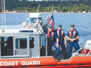 Above: Being a member of the U.S. Coast Guard Auxiliary gives members some interesting opportunities. Local Auxiliary member John Ceryes visited the North Superior Coast Guard Station in Grand Marais on Sunday, September 4. He was able to take a short monitoring cruise with the active duty Coast Guard personnel before they left for the season. Left: Coast Guard Auxiliary members like Ceryes and Heinz Ledowski of Silver Bay manned the Coast Guard Auxiliary booth at Fisherman’s Picnic, providing safe boating information to the public. They also spoke to visitors about joining the Coast Guard Auxiliary.