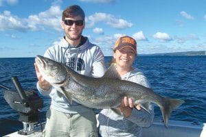 Meredith Abbott from Minneapolis caught this beautiful 21-pound, 39-inch lake trout while fishing with Captain Darren Peck of Tofte Charters. Helping her hold the monster trout is her husband, Adam. The fish was released.