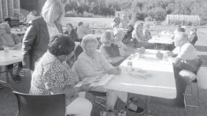 Above: Rendezvous Days Elder volunteers enjoyed the annual appreciation BBQ. Left: Elvis with his best fan, Darlene LeGarde, who is moving to Iowa to be closer to family.