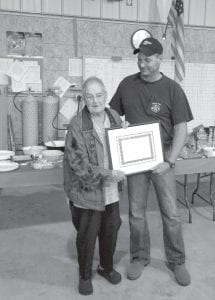 Left: Eleanor Waha of Grand Marais has served the community in many ways. She recently stepped down from one of her volunteer activities, as a board member of the Maple Hill Community Fire Department. The Maple Hill Community Fire Department honored Eleanor at their annual meeting on Wednesday, September 7. Fire Chief Kent Anderson presented her with this framed certificate declaring her “Board Member Emeritus.” Above: Eleanor was recognized for her 40 years of service to the department with flowers, gift cards, and this beautiful seven-layer cake made by Lyndsay Anderson.