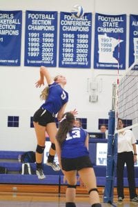 Above: Making a nice set on the ball is Tarin Hanson (No. 6). Left: Meredith Sutton soars high like an angry bird, as she gets ready to put more than a little “heat” on this spike.