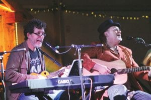 Grammy award winner Jon Vezner (left) and Don Henry harmonized together at the Unplugged concert held over the weekend at the North House Folk School campus. Vezner is ending a 15-year stint as the organizer of Unplugged, but the good news is that he has vowed to come back and assist with the fundraising event for the folk school.