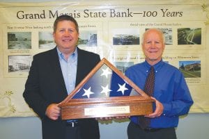 Few businesses stay in operation for 100 years, but Grand Marais State bank is an exception to that rule. In honor of that, Jim Amundson, president and CEO of the Independent Community Bankers of Minnesota presented Grand Marais State Bank President Mike LaVigne with a commemorative U.S. flag encased in glass and wood with an inscription in brass noting the occasion.