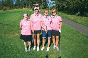 Left: Nancy Hanson, Lori Backlund, Mary Brislance and Helen Carter had a great time on the course raising money for a great cause. Above: Debby Rebischke (left) and Darla Friest were the “busy bees” in charge of the putting contest.