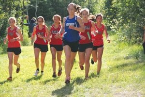 Top: Maya McHugh was dogged by a pack of Duluth East Greyhounds at a recent meet at Pincushion Mountains. She finished well at the Eveleth Lions Invitational cross country meet.