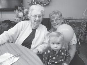 Above: Helene Smith celebrated her birthday with friends and family at Sawtooth Ridges. (L-R) Helene Smith, Robin DuChien, and Autumn. Left: Marlys Sherer holds the gigantic zucchini she won when she guessed its weight within a few ounces! Thanks to Diane Nowers who donated this giant from her garden for this fun event.