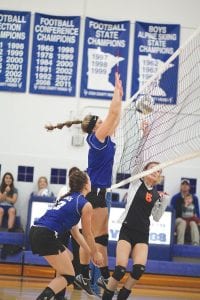 Left: With Alyssa Lashinski (No. 13) ready to make a play, Emily Jacobsen went up high to block this ball back into the Wrenshall Wren court in the Vikings’ 3-0 win over the Wrens. Top: Backcourt specialist Raina Ryden contorts her body to bump the ball. Above: Hannah Borson gets ready to take a ball off of the floor.