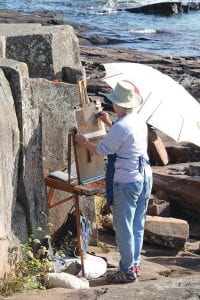 Paintings from the Grand Marais Art Colony Plein Air are on display at Johnson Heritage Post and the Art Colony now until November 13. Gallery visitors will be able to see the finished works like this one being completed during the Quick Paint contest by Michelle Wegler. Her painting of a fall leaf resting on the craggy rocks of Artist Point is titled Passages.