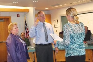 Todd Smith, who has been working in the Cook County Assessor's Office since March 2015 takes the oath of office to become the new Cook County assessor on September 27. Court Administrator Kim Shepard administers the oath as Smith’s wife, Pat looks on.