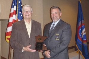 Standing with Cook County Sheriff Pat Eliasen, Jim Wiinanen (left) displays the plaque he received after the announcement was made that he had been voted Emergency Director of the Year for the state of Minnesota at the Association of Minnesota Emergency Managers’ conference held at Breezy Point in Brainerd.