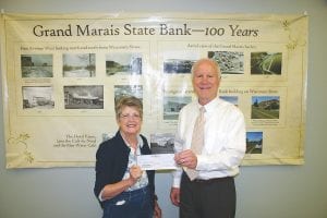 Grand Marais State Bank President Mike LaVigne was more than happy to present a $1,000 check to the Cook County Food Shelf to Gwen Lenz on behalf of the bank’s celebration of its 100-year anniversary celebration. The gift was greatly appreciated, said Lenz.