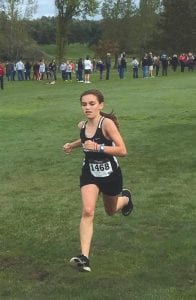 Above: Feeling good, Anna Hay sprinted for the finish line at Swain. Left: Cecelia Chmelik shows the effort of running a fast pace over the hills at Swain.