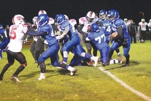 Sam O’Phelan had a huge day running the ball against the Isle Huskies last week. A big part of that, of course, were his blockers who sealed off corners for him to run around like this one above. Here lead blocker Dylan Sjogren is followed by Andrew Miller and Ben Trepainer (77) as they “set” the table for O’Phelan by crushing the defensive players trying to stop him from making another big gain on the ground.