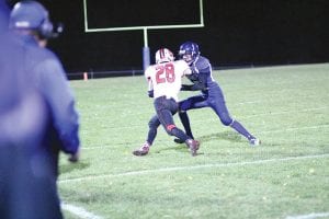 Above: Connor Somnis corralled the Isle ball carrier, stopping him from gaining more than a few yards on this play. Right: Jack Haussner made sure the Isle ball carrier didn’t gain one more inch on this play.