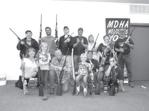 Gun winners at the Arrowhead Chapter of the Minnesota Deer Hunters Association banquet were, starting in the front row L-R: Laura Smith, Grete Youngdahl, Tim Quaife, Kallie Anderson, Gary Radloff, Aurielle Housey. Back row L-R: Brandon Diaz, Joey Brazell, Skylar Johnson, Charlie Trovall, Paula Schaefbauer, Donna Lunke and Orvis Lunke.