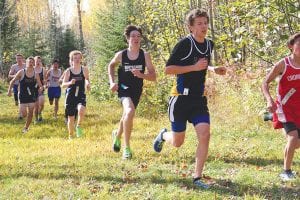 Above: Will Surbaugh leaves some runners in the dust and gets ready to pass another runner in the conference meet. Surbaugh earned All- Conference honors with his 7th place finish in the race. Far left to right: Saira Smith, Daphne Lacina, JC Holman, Kevin Viren.