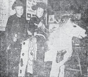 First-grader Gary Giroux rides a papier-mache horse he and his classmate constructed as a class project in this May 22, 1952 photo. The gun totin’ cowboy is Michael Owens. Both attend the Grand Marais school.