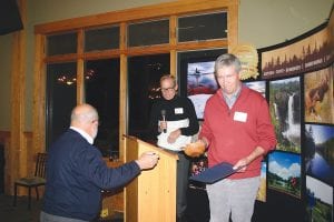 Left: An unexpected announcement came when Tom Rider called on a very deserving (but self-deprecating) Scott Harrison to come forward to receive the Chairman Award for Visionary Leadership. Above: Chuck Corliss and Kim Schroeder were the recipients of the Entrepreneur of the Year Award for their North Shore Winery business which is located on the Lutsen Ski Hill Road.