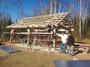 Mark Adams designed and built this post and beam building at the Hovland Town Hall. When it is completed it will serve as the community picnic shelter for the new playground and park that is located on the east side of the town hall. The picture shelter and playground have been in the planning stages for years. Recent improvements to the town hall include painting the building, installing new playground equipment, and leveling the ground where the kids will play. Several informational meetings hosted by east end county commissioner Frank Moe have also been held at the town hall—there has even been some talk of renewing the former Hovland Community Club as a way to bring the community together. Pictured here from L-R: Meadow Adams, Mark Adams and Joel Lewis.