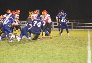 Left: Billy Hackett (74) and his teammates crashed through the offensive line and stopped the MIB runner in his tracks. Above: Ben Trepanier (77) escorted Andrew Miller down the field on this play. Trepanier took out an MIB defender with an excellent downfield block to give Miller more running room.