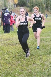 Left: Working hard, Aurora Schelmeske and Chloe Blackburn look good at the conference meet. Above left: Showing great running form is Elsa Garry. Above right: Pushing hard to the finish was Doren Acero.