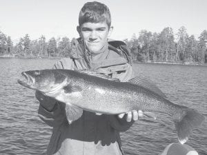 Tommy Fischer, age 14, caught and released this 31¾-inch hawg walleye on Saganaga Lake October 22 while guided by Cory Christianson