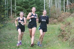 From L-R, Autumn Smith, Maya McHugh, and Cedar Gordon run together in a recent home cross country meet. Smith finished 32nd at the Section 7A meet, while Gordon placed 33rd and McHugh came in 39th place. The North Shore Storm girls finished sixth out of 15 teams at the state-qualifying meet.